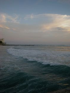 the ocean waves are crashing on the beach