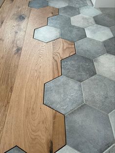 a wooden floor with several hexagonal tiles on the floor and in between them