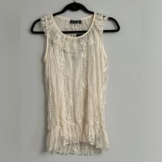 Excellent Condition Sleeveless Blouse. Lace Design Throughout. Pit To Pit= 16.5” Fitted Sleeveless Cream Lace Top, Feminine Sleeveless Cream Blouse, Feminine Cream Sleeveless Blouse, Cream Sleeveless Lace Top, Fitted Lace Tank Top Blouse, Fitted Lace Tank Blouse, Sleeveless Lace Blouse For Summer, Sleeveless Lace Top For Spring Daywear, Cream Sleeveless Top For Daywear