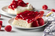 two pieces of cake with raspberry sauce on them