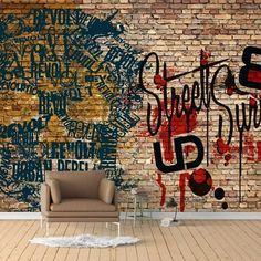 a brick wall with graffiti written on it and a chair in front of the wall