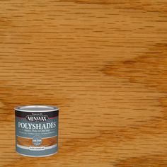 a can of minwax polyshades on top of a wooden table with the paint in it