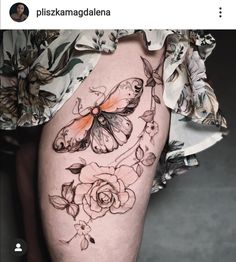 a woman's thigh with butterflies and roses on it, as well as the bottom part of her leg