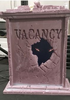 a pink sculpture with the word vacancy written on it