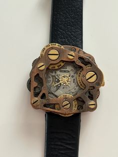 This stunning vintage steampunk watch gear timepiece is in very good condition, showcasing its intricate mechanical design and craftsmanship. It features an eye-catching blend of vintage aesthetics and industrial flair. Please note that there is one minor defect: the leather strap has a small imperfection as you can see in the photos, but it does not detract from the overall beauty of this unique piece. Perfect for collectors or anyone looking to add a touch of steampunk style to their collection! My items are all vintage or antique and have been used or displayed. Due to age, some imperfections or manufacturing defects may be present. Please take your time to review the photos carefully as they are part of the item description; we do our best to ensure that the pictures show all aspects o Steampunk Watches, Watch Gears, Steampunk Watch, Vintage Steampunk, Style Steampunk, Vintage Aesthetics, Watch Gift, Steampunk Style, Mechanical Design