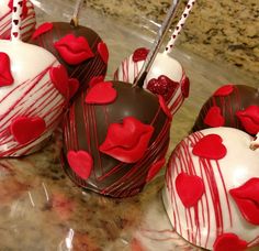 chocolate covered strawberries with red and white decorations