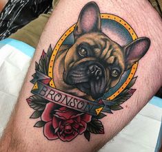 a bulldog tattoo on the leg of a man's leg with roses around it