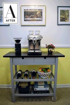 a coffee bar with wine bottles, cups and other items on it in front of a yellow wall