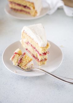 a piece of cake on a plate with a fork next to it and another slice in the background