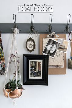 there is a coat hook on the wall with pictures hanging from it's hooks