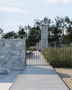 a gated walkway leading to a stone building