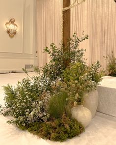 an arrangement of flowers and greenery on the floor