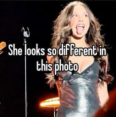 a woman standing in front of a microphone with the caption she looks so different in this photo