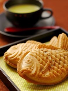 some kind of food on a tray next to a cup