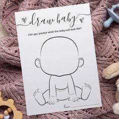 a card with a drawing of a baby on it next to some teddy bears and other toys