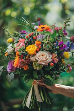 a person holding a bouquet of flowers in their hand