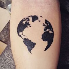 a person with a tattoo on their leg that has the image of the earth painted on it