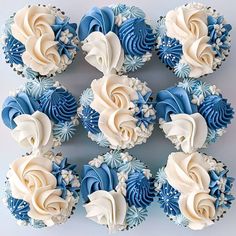 cupcakes with blue and white frosting are arranged in the shape of flowers