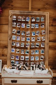 an old dresser with pictures hanging on it