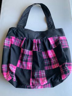 This one of a kind purse is a pink plaid  patchwork with a black band and straps and black lining. It is 16 inches long and 18 inches wide with a 10 inch strap drop. Inside it has an open pocket on one side. It is made of cotton and polyester and is washable. Square Black Bags With Patchwork, Pink Patchwork Bag For Everyday Use, Patchwork Shoulder Bag For Shopping, Affordable Pink Patchwork Bags, Pink Rectangular Patchwork Bag, Vintage Multicolor Patchwork Shoulder Bag, Pink Plaid, 10 Inch, Purses And Handbags