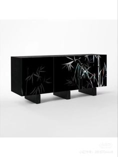 a black cabinet with bamboo designs on it