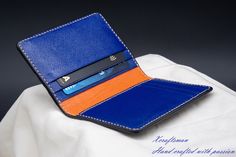 This wallet is unique, you will never see the exact same thing. The exterior alligator leather is cut along its scale's edge to show an orange layer below. The orange line is unique because the texture of the alligator is unique. The wallet opens vibrantly with blue and orange color inside. I've tried my best to put my unique technique and my passion into this small piece. Every single wallet is made to order, there won't be a second same thing. If you are looking for a small accessory but it's Luxury Blue Card Holder As Gift, Luxury Blue Card Holder For Gift, Luxury Blue Card Holder Gift, Blue Leather Card Holder With Interior Slots, Blue Leather Card Holder For Formal Use, Blue Leather Business Card Holder, Designer Blue Card Holder For Everyday, Blue Bifold Card Holder For Formal Occasions, Blue Rectangular Card Holder For Formal Occasions