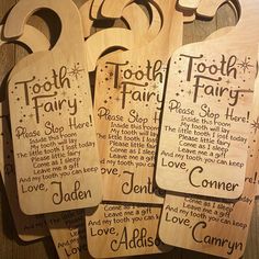 four wooden tooth fairy tags on a table