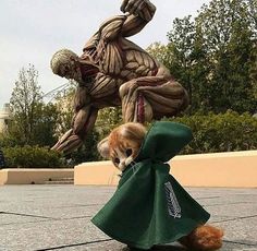 an image of a dog in front of a statue that looks like a human figure