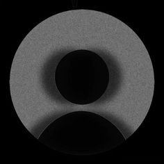 a black and white photo of a circular object with two circles on it's side