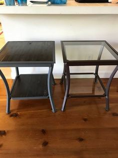 two glass tables sitting on top of a wooden floor