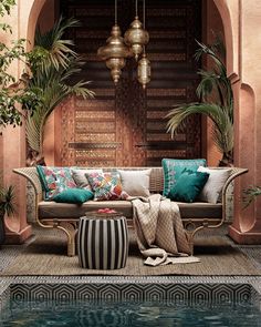 a living room filled with lots of furniture next to a swimming pool and potted plants