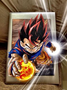 an image of a dragon ball being held by someone's hand on a couch