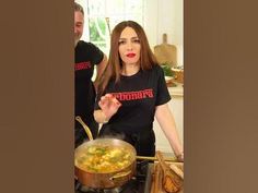 a woman cooking food in a pot on the stove