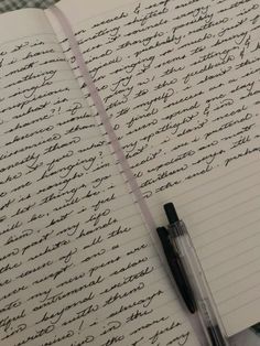 an open notebook with writing on it next to a pen