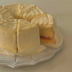 a white cake on a plate with one slice cut out and ready to be eaten