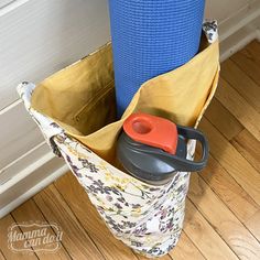 a pair of scissors sits in a bag on the floor next to a yoga mat