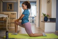 a woman is doing yoga in the living room