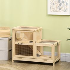 a cat house with two cats inside and one on the floor in front of it