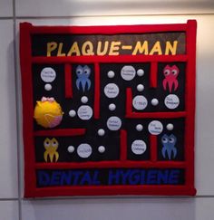 a sign that says plaque - man dental hygiene on the side of a white wall