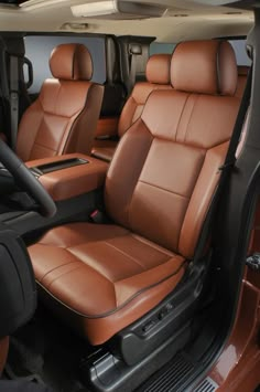 the interior of a vehicle with brown leather seats