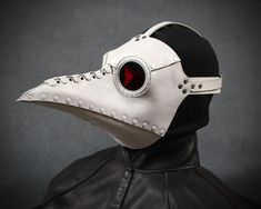 "This mask is identical to our popular plague doctor mask Schnabel, but made to accommodate eyeglasses. It measures about 12\" long not counting the straps. The leather mask is mostly riveted together with some hand-stitching and some metal leather staples. The eyepieces are hand sewn in with waxed thread. The mask comes in white with red lenses. It is made of medium weight veg tanned leather and has an adjustable strap. It comes with two series of ventilation holes on the top and bottom of the White Plague Doctor, Plague Dr Mask, Plague Dr, Steampunk Plague Doctor, Beak Mask, Plague Doctor Costume, Plague Mask, Plague Doctor Mask, Steampunk Mask