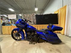 a blue motorcycle is parked in a warehouse