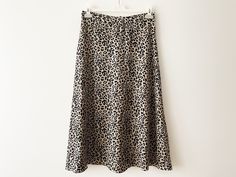 "Vintage Animal print midi skirt, a-line women's skirt, lightweight leopard print skirt, beige black cheetah print women skirt, gift idea for her Measurements: Waist: 29.5\" Hips: 41\" Length: 33\" Please check measurements to insure a proper fit. Remember to allow yourself some extra room for movement. You can compare these with something from your closet that fits you well. Condition: Good vintage condition SHIPPING * I ship worldwide via Priority mail (Latvijas Pasts) from Latvia (EU). * I ship from Europe, so please allow 2 to 4 weeks for the package to arrive if you live overseas. * Europe 5 - 10 business days. Go back to my shop: YourEclecticStreet.etsy.com P.S. why buy Vintage? - Vintage is Unique! - Vintage is Eco Friendly! - Vintage is Inspirational! - Vintage is History! - Vintag Leopard Print Long Skirt For Spring, Long Leopard Print Skirt For Spring, Leopard Print Relaxed Midi Skirt, Leopard Print Relaxed Fit Midi Skirt, Casual Leopard Print Pencil Skirt, Leopard Print Flowy Long Skirt, Chic Flowy Leopard Print Skirt, Chic Leopard Print Midi Skirt, Flowy Long Leopard Print Skirt