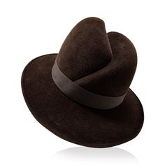 Supple velour finish felt is hand blocked into the Gigi Burris signature front scar fedora. The piece is trimmed with sateen ribbon trim and silver metallic hardware. Named after Gigi's great-grandmother, this is the fedora synonymous with Gigi Burris Millinery. The shape has been seen on celebrities including Jodie Turner-Smith and Rita Ora. Gigi Burris Millinery was founded to preserve the romantic craft of millinery, we work to ensure timeless design and thoughtful craftmanship in every piece Luxury Fur Felt Hat With Curved Brim, Luxury Wide Brim Fur Felt Hat, Luxury Brimmed Fur Felt Hat, Luxury Fur Felt Hat With Short Brim, Luxury Felt Fedora Hat, Luxury Brown Fur Felt Hat, Formal Felt Fedora With Flat Brim, Formal Felt Fedora Hat, Elegant Felt Fedora For Formal Occasions