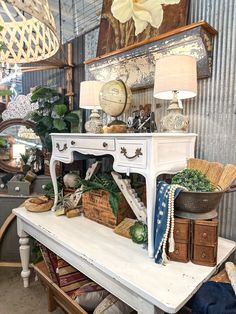 a white table topped with lots of different types of furniture and decor on top of it