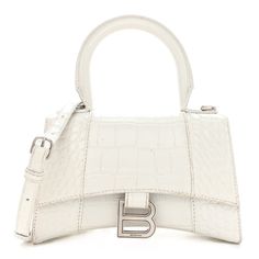 This is an authentic BALENCIAGA Shiny Calfskin Crocodile Embossed Hourglass Top Handle Bag XS in White. This stylish and structured handbag is crafted of crocodile embossed white calfskin leather. The bag features a sturdy leather top handle with ruthenium links and a prominent B logo on the front flap, and an optional, adjustable shoulder strap. The front flap opens with a magnetic snap closure to a smooth white leather compact interior. Balenciaga Shoulder Bag White, Shiny Handbags, B Logo, White Handbag, Balenciaga Bag, Chic Bags, Small Handbags, Ballet Flat Shoes, White Bag