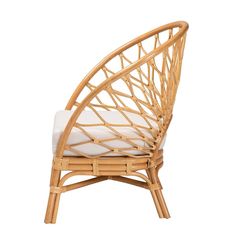 a wicker chair with white cushions on it