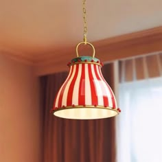 a red and white striped light hanging from a ceiling