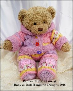 a brown teddy bear sitting on top of a white bed covered in pink and yellow knitted clothing