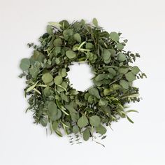 a wreath made out of green leaves on a white background